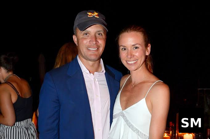 Couple posing at evening event.