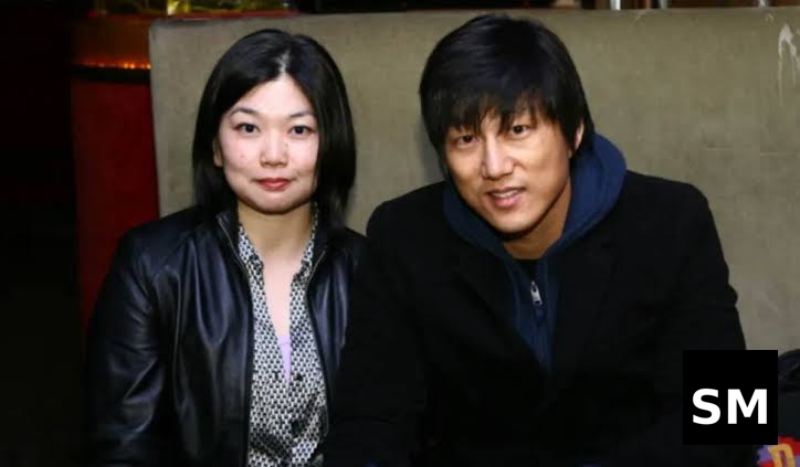 Two people sitting together indoors.