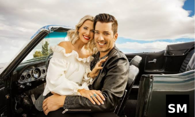 Couple in classic convertible car.