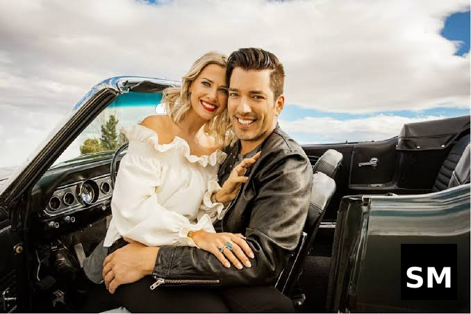 Couple in classic convertible car.
